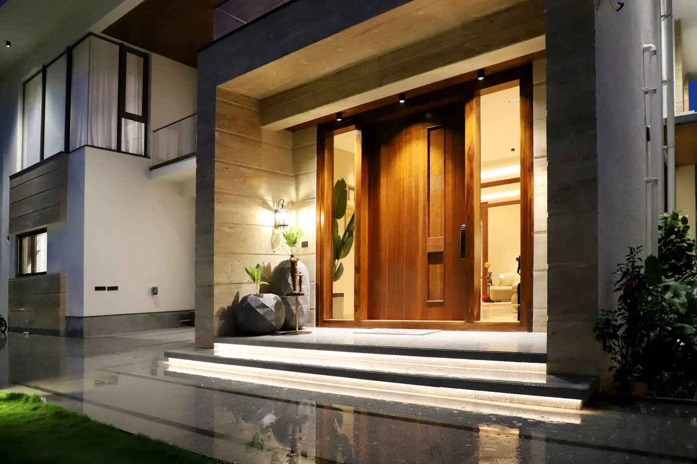 Modern home entrance lit up at night
